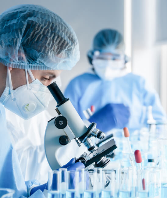 Man lookig through microscope