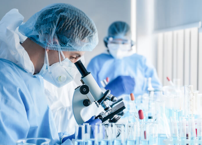 Man lookig through microscope